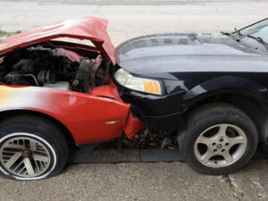 Frontal collision of a red and a black car