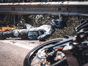 A motorcyclist on the ground after a crash