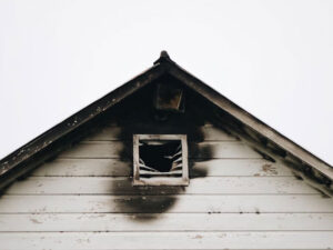 The top of a white house after a fire