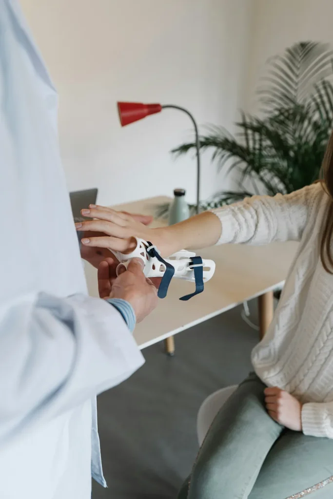 Person Getting a Wrist Brace From a Doctor