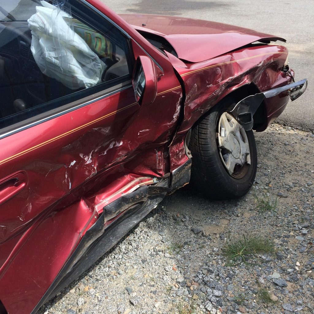 The aftermath of a severe car accident, showing a close-up of a totaled vehicle